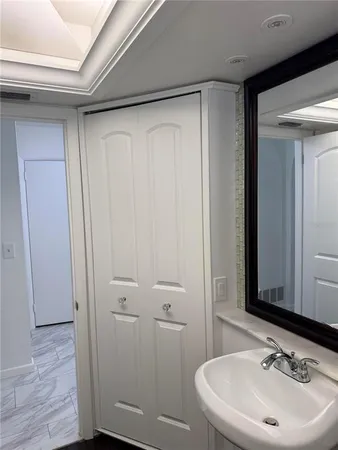 a white toilet sitting next to a small window