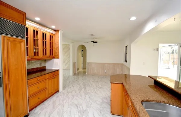 a open kitchen with cabinets a sink and wooden floor