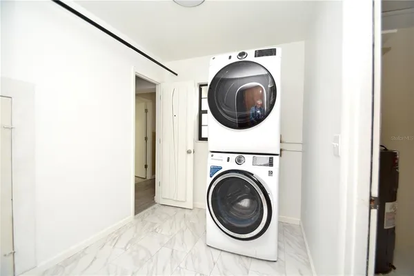 a view of a hallway with washer and dryer