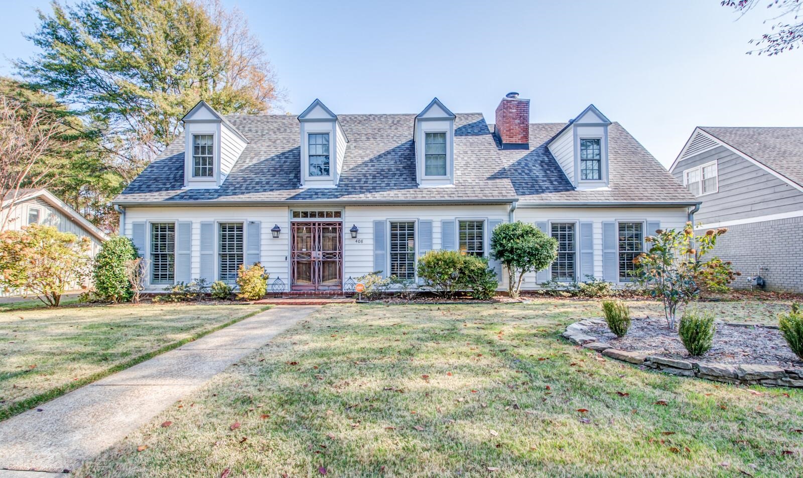 a front view of a house with garden and porch