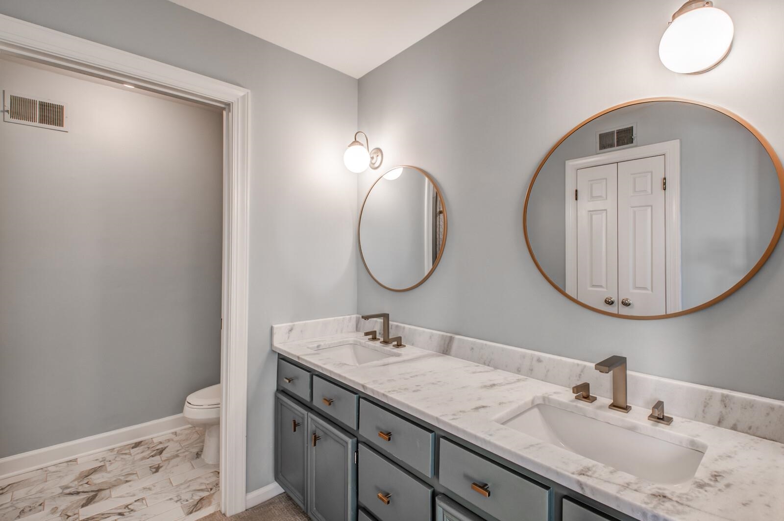 408 Avon Road Memphis, TN 38117 - Photo 15 of 25 a bathroom with a granite countertop double vanity sink and a mirror
