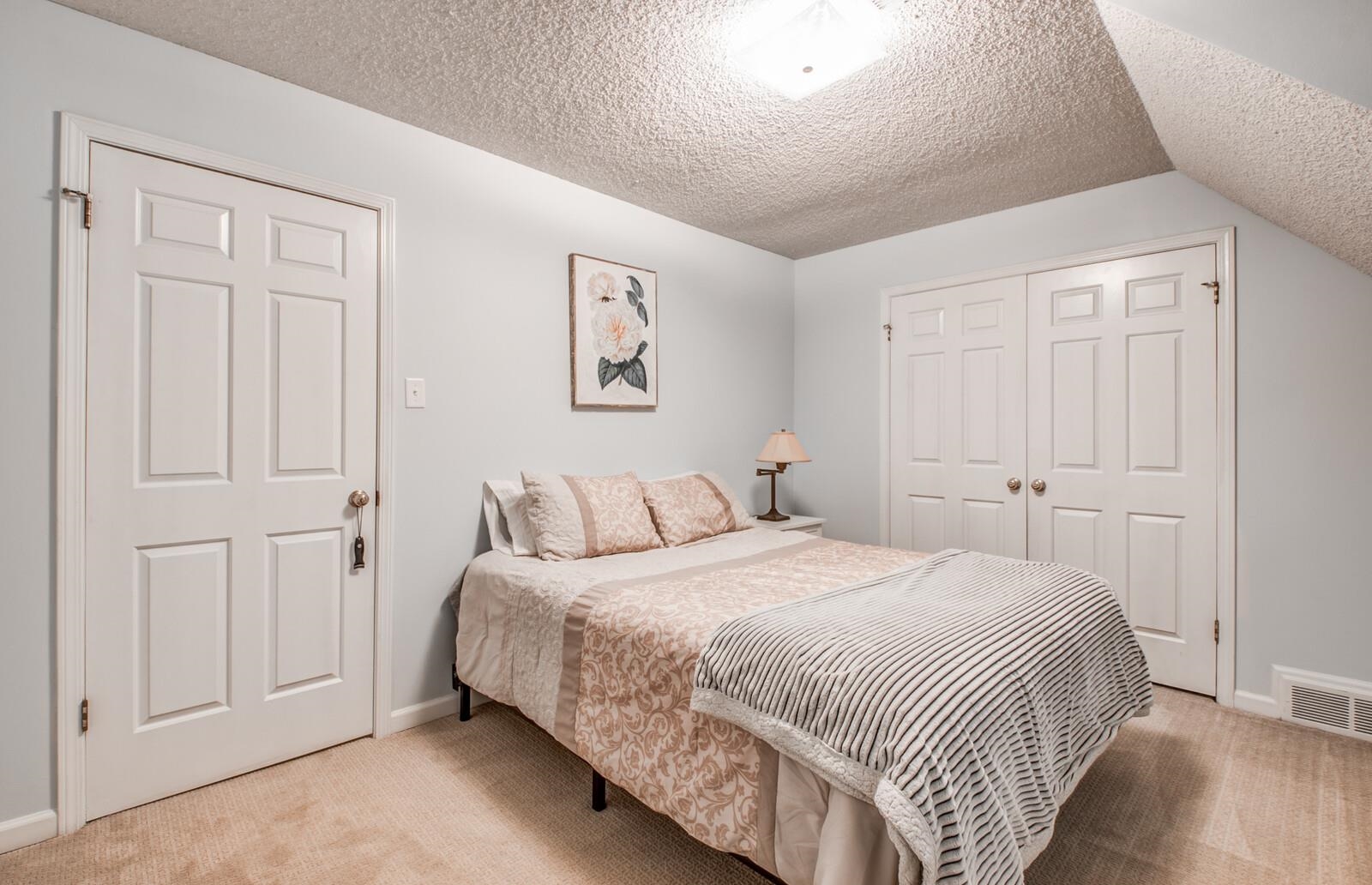 408 Avon Road Memphis, TN 38117 - Photo 19 of 25 a bedroom with a bed and painting on the wall