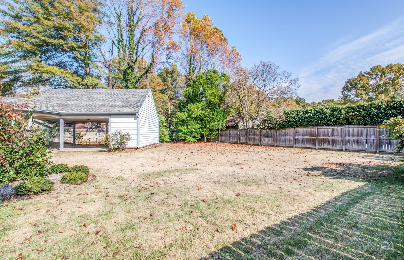 408 Avon Road Memphis, TN 38117 - Photo 24 of 25 a view of a house with backyard and a tree