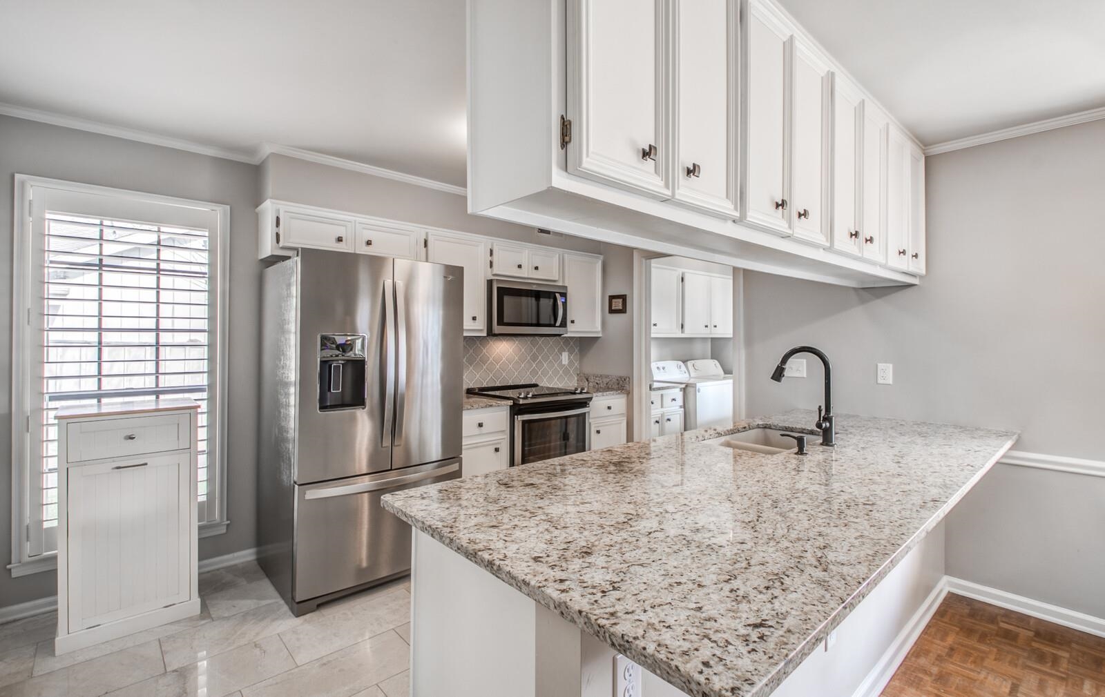 408 Avon Road Memphis, TN 38117 - Photo 9 of 25 a kitchen with stainless steel appliances granite countertop a refrigerator sink and cabinets