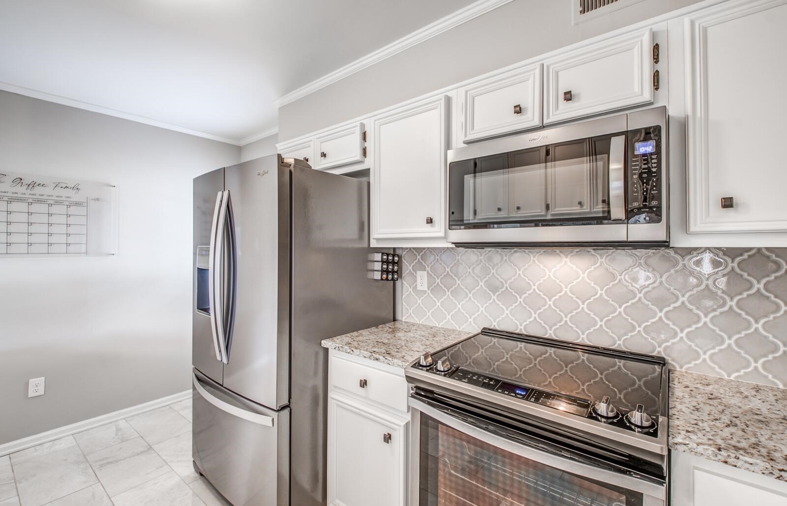 408 Avon Road Memphis, TN 38117 - Photo 10 of 25 a kitchen with granite countertop cabinets and steel stainless steel appliances