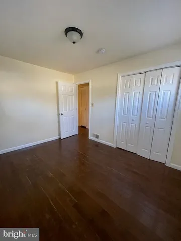 an empty room with wooden floor