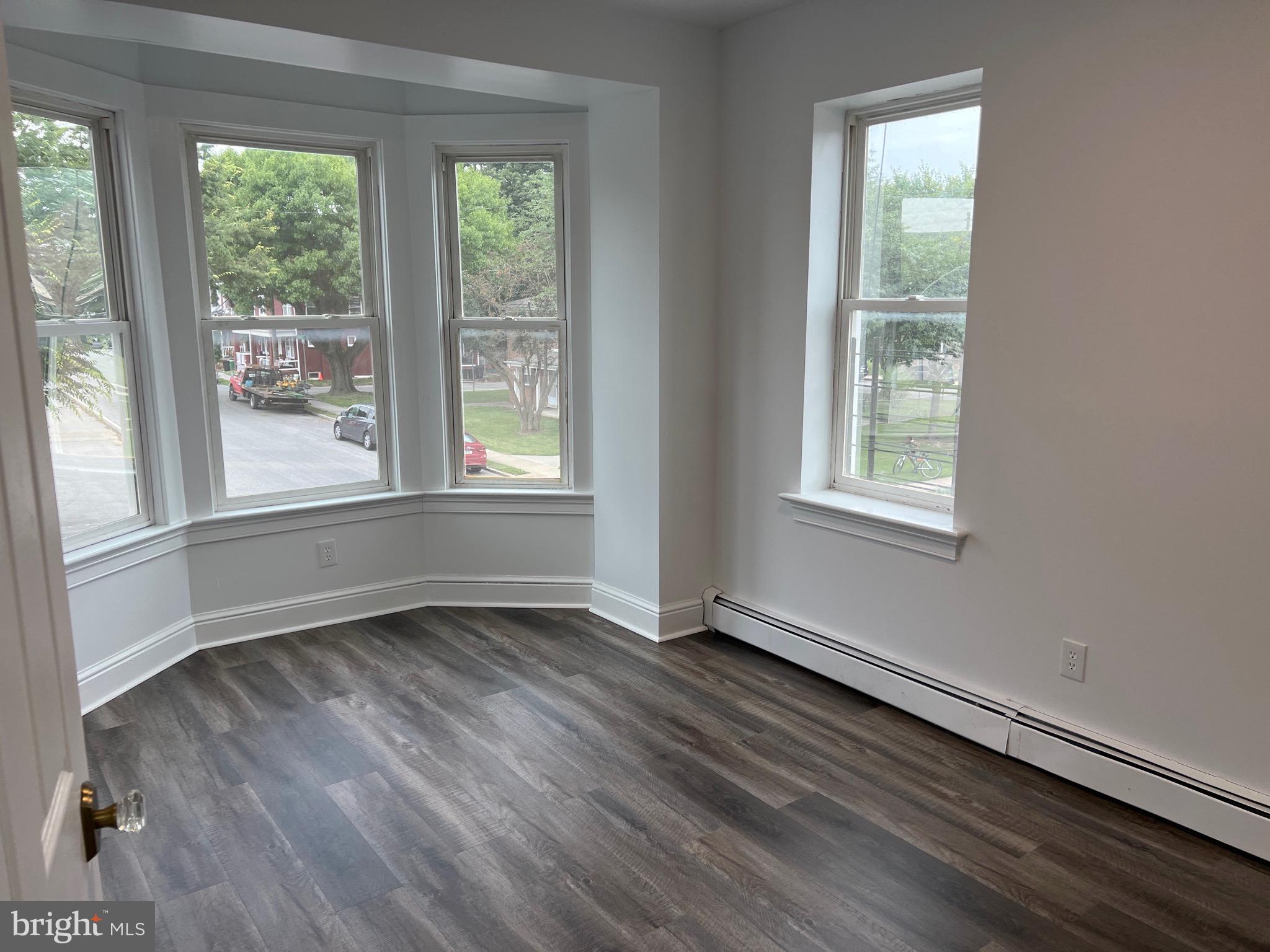 533 Thomas Street York, PA 17404 - Photo 12 of 26 an empty room with wooden floor and windows