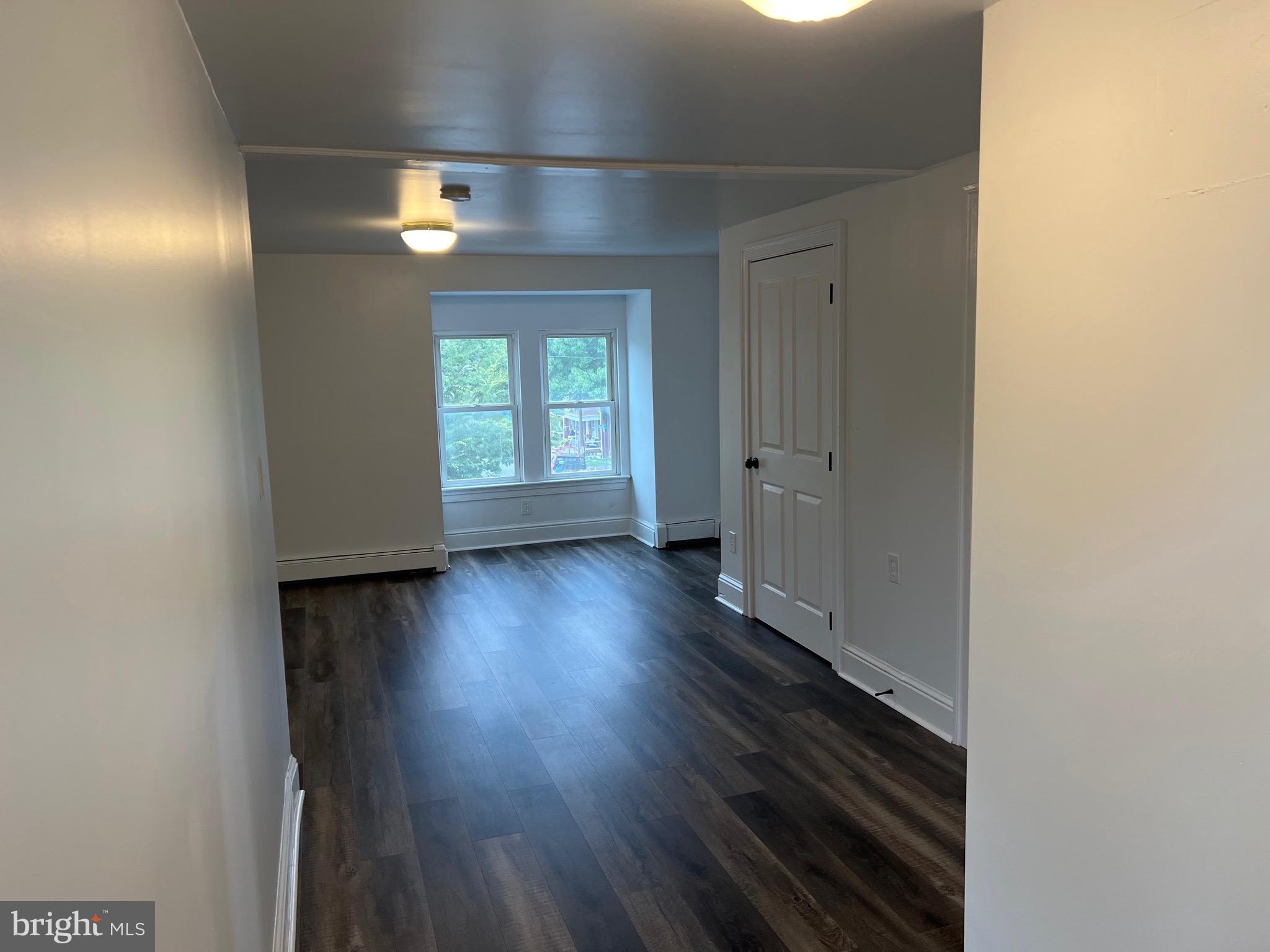 533 Thomas Street York, PA 17404 - Photo 14 of 26 an empty room with wooden floor and windows