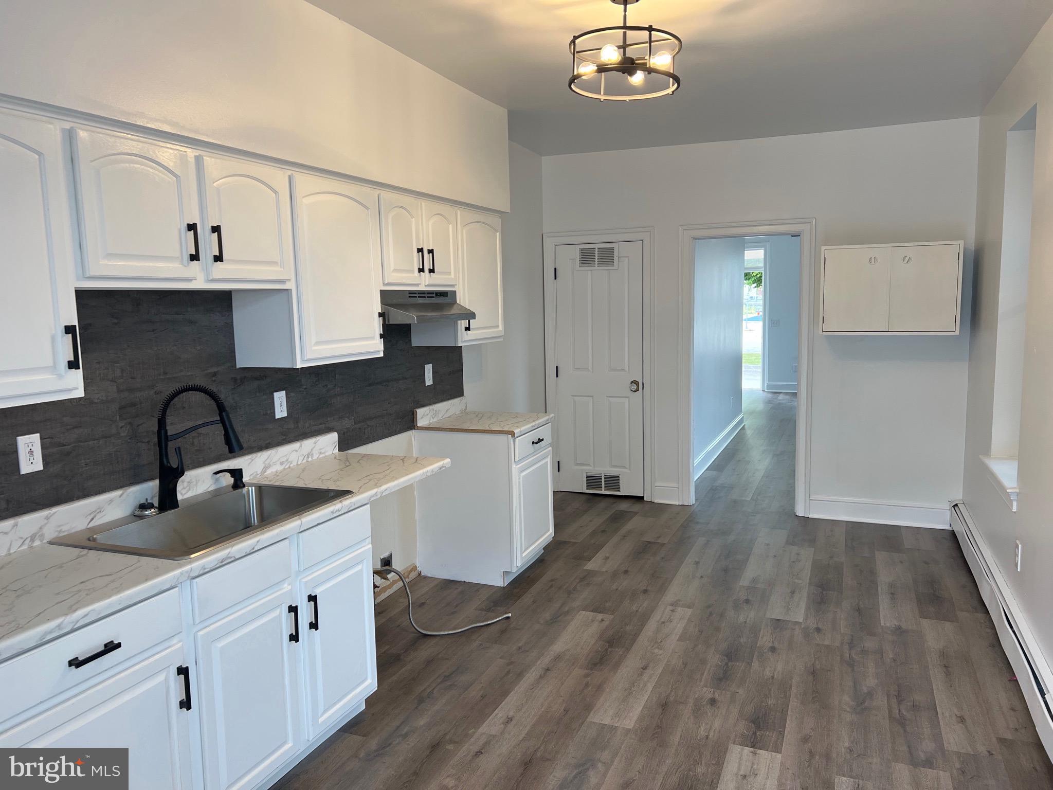533 Thomas Street York, PA 17404 - Photo 8 of 26 a kitchen with wooden floors a sink and cabinets