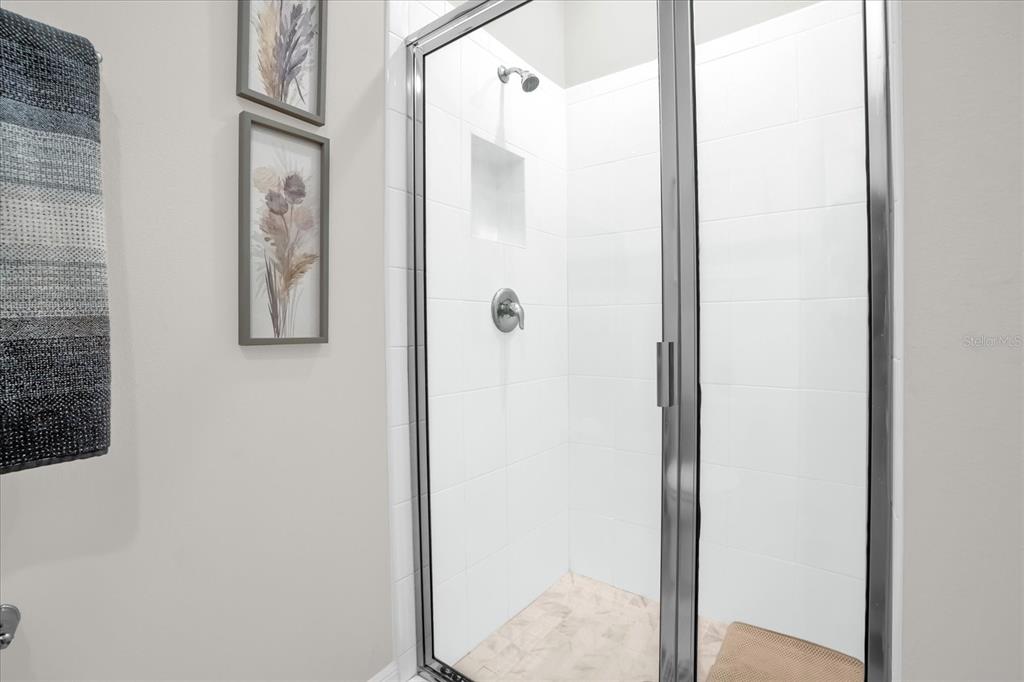 6775 Sarus Crane Point Harmony, FL 34773 - Photo 11 of 28 a bathroom with a shower
