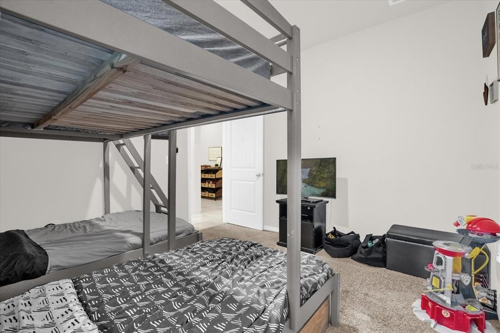 6775 Sarus Crane Point Harmony, FL 34773 - Photo 17 of 28 a bedroom with a bed and a couch