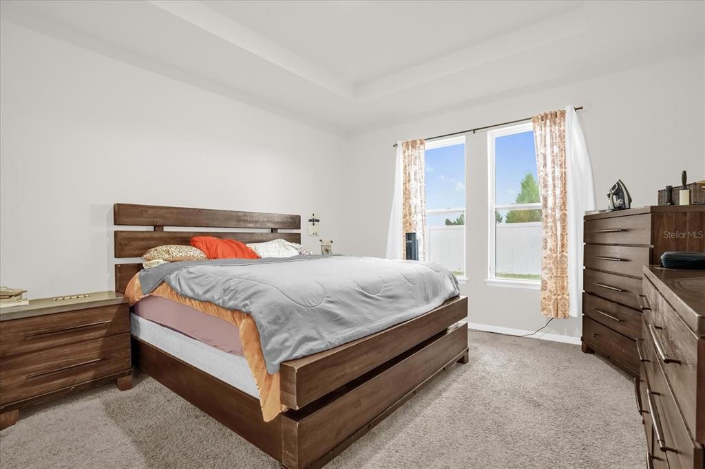 6775 Sarus Crane Point Harmony, FL 34773 - Photo 19 of 28 a bedroom with a bed and dresser