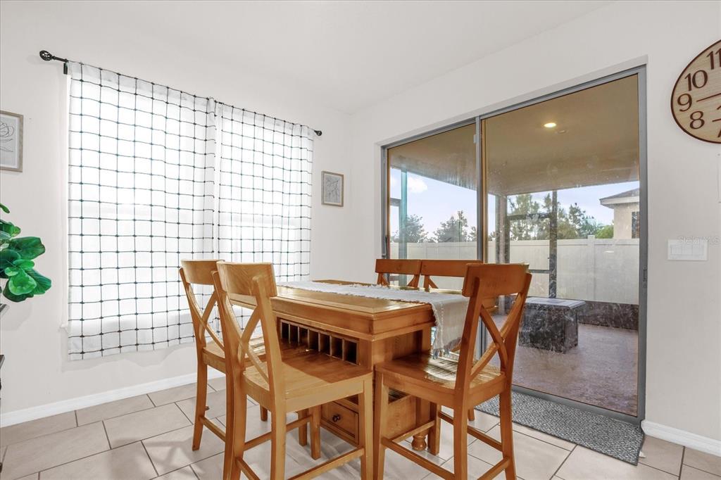 6775 Sarus Crane Point Harmony, FL 34773 - Photo 7 of 28 a view of a dining room with furniture and chandelier