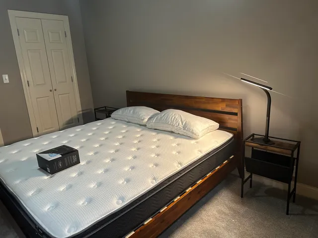 a bed sitting in a bedroom next to a window