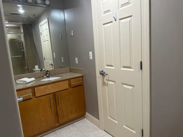 a bathroom with a double vanity sink shower and a mirror