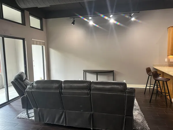 a living room with furniture and a chandelier