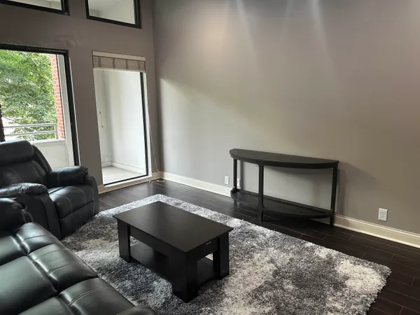 a living room with furniture and a rug