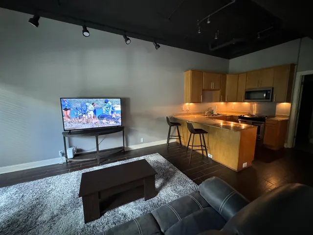 a front view of a building with glass windows and a tree
