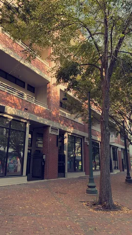 a front view of a building with glass windows and garage