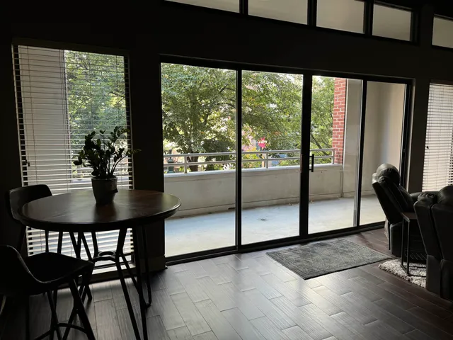a view of a room with a table and chairs