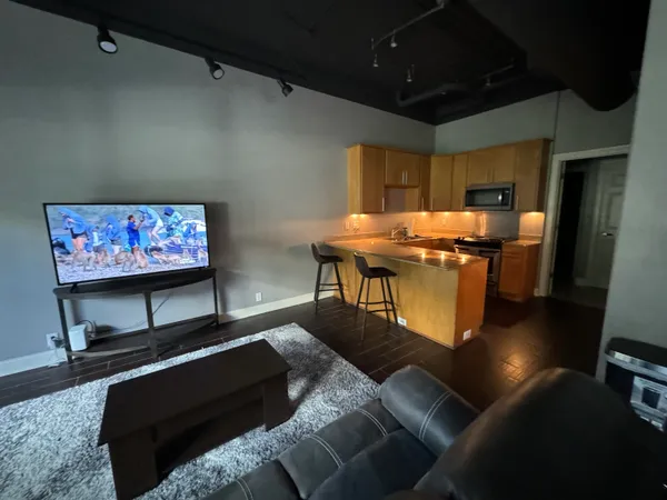 a living room with couch and a flat screen tv