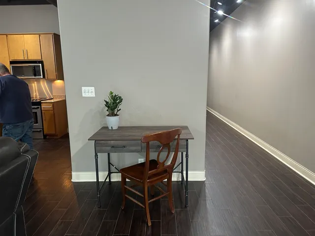 a view of a dining room with furniture and wooden floor