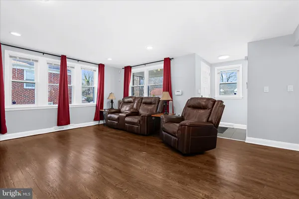 a living room with furniture window and wooden floor