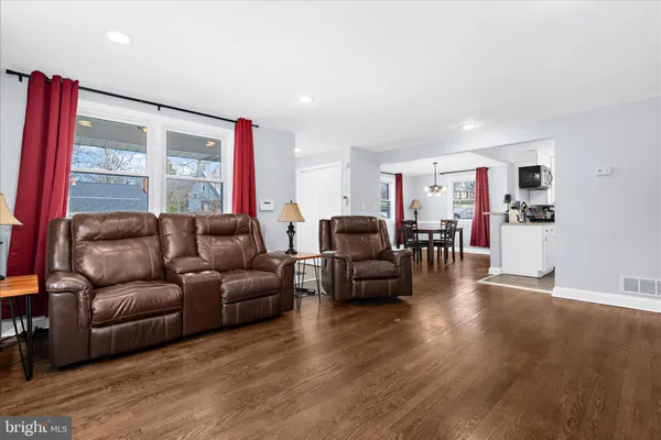 a living room with furniture window and wooden floor
