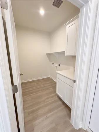 an empty room with a ceiling fan and window