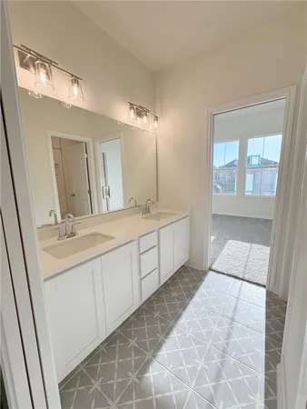 an empty room with a ceiling fan and window