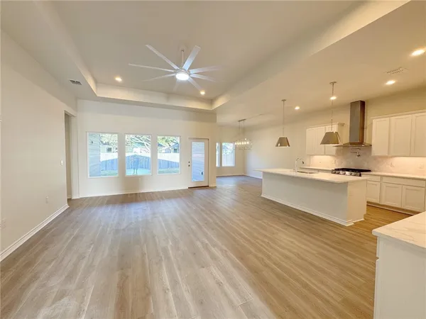 a view of kitchen with wooden floor and windows