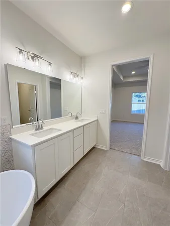 a spacious bathroom with a bathtub and shower