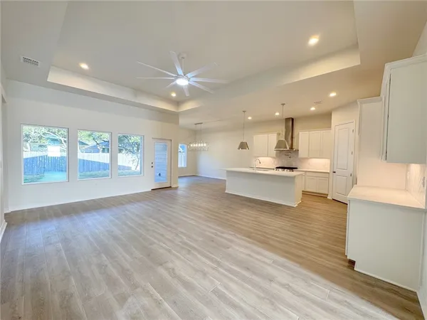 a view of kitchen with kitchen island and stainless steel appliances