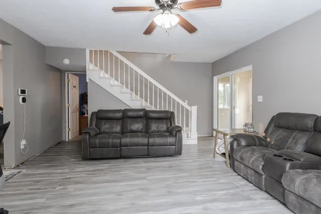 a living room with furniture and stairs