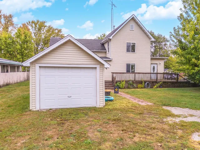 a view of a house with a yard and garage