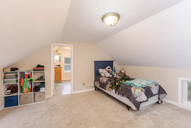 a bed room with a bed and a book shelf