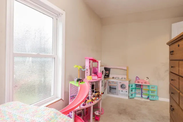 a bedroom with a bed and a dresser