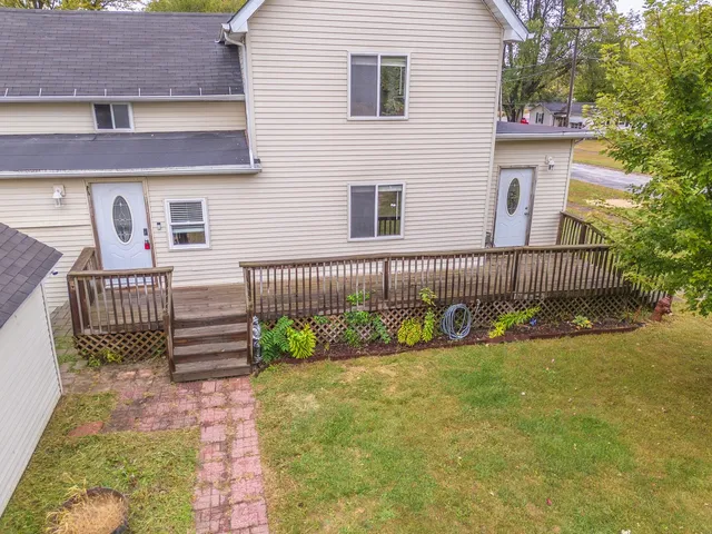 a view of a house with wooden fence