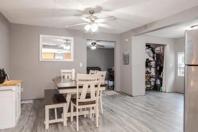 a view of a dining room with furniture and wooden floor