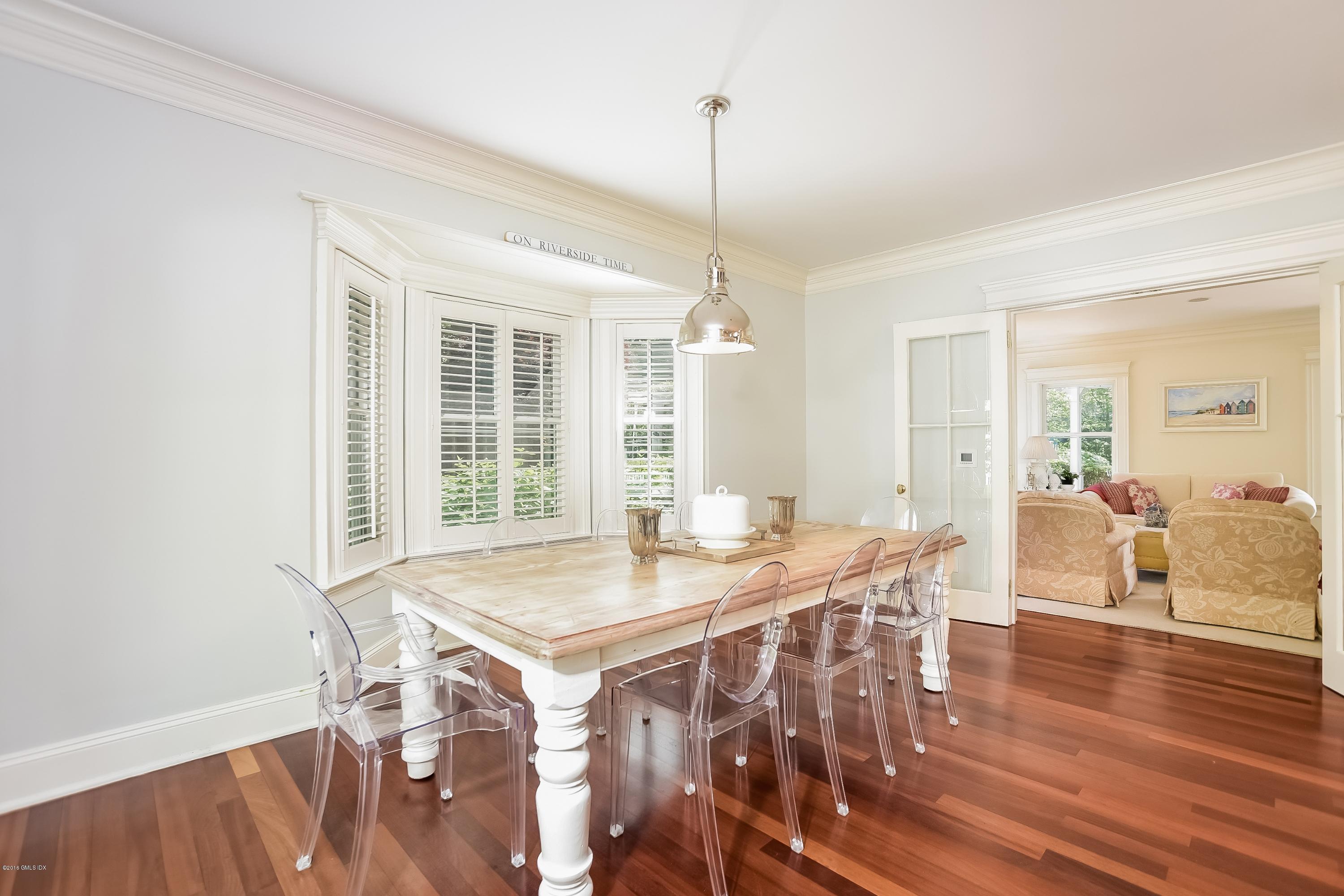 35 Lockwood Road Riverside, CT 06878 - Photo 11 of 39 a view of a dining room and livingroom with furniture wooden floor a chandelier