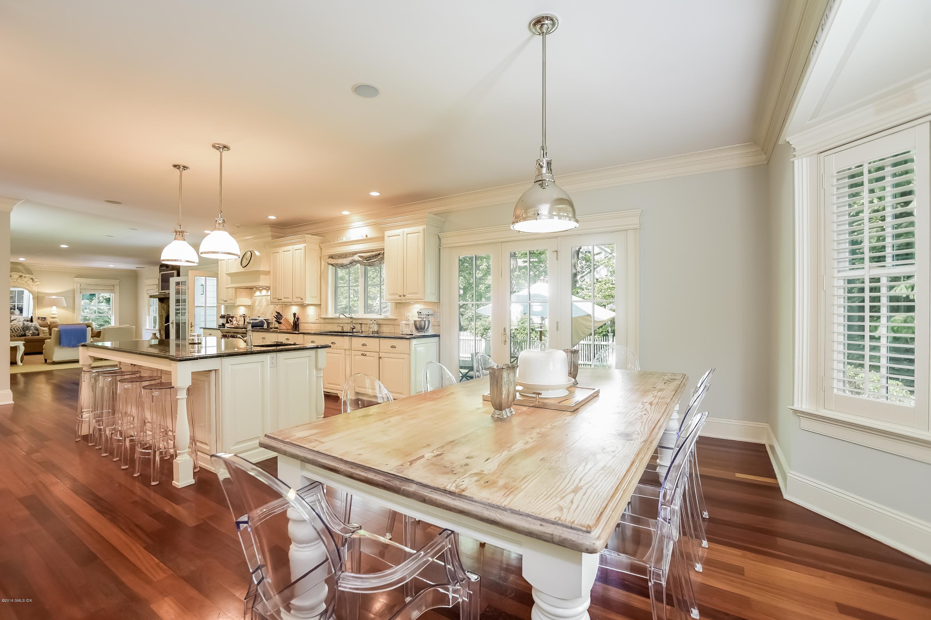 35 Lockwood Road Riverside, CT 06878 - Photo 12 of 39 a view of a dining room and livingroom with furniture wooden floor kitchen chandelier
