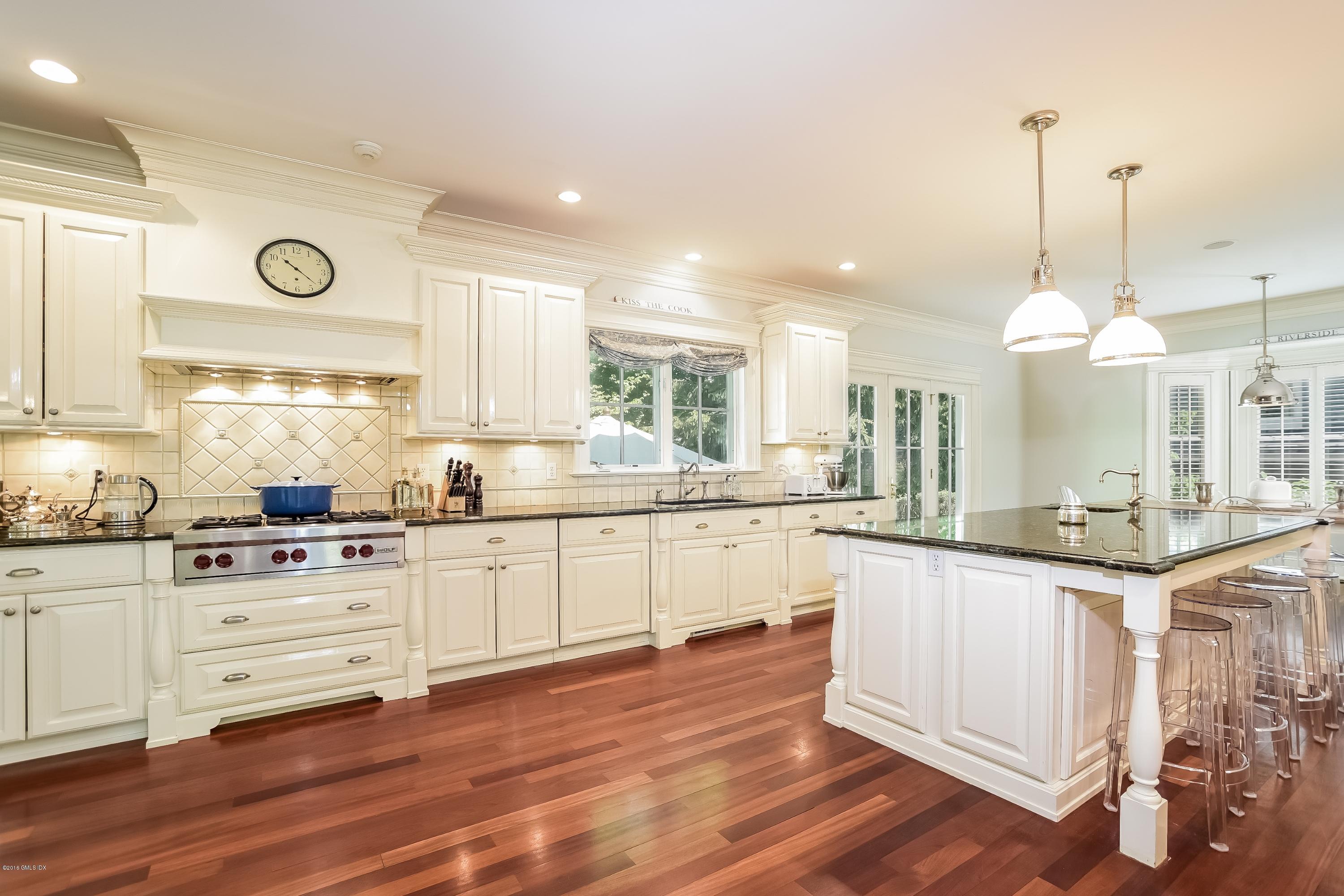 35 Lockwood Road Riverside, CT 06878 - Photo 13 of 39 a kitchen with granite countertop white cabinets and white appliances