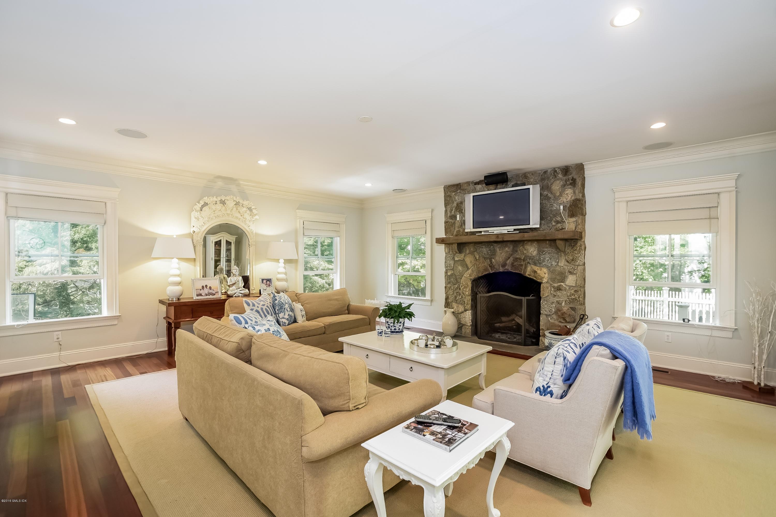 35 Lockwood Road Riverside, CT 06878 - Photo 16 of 39 a living room with furniture a fireplace and a table