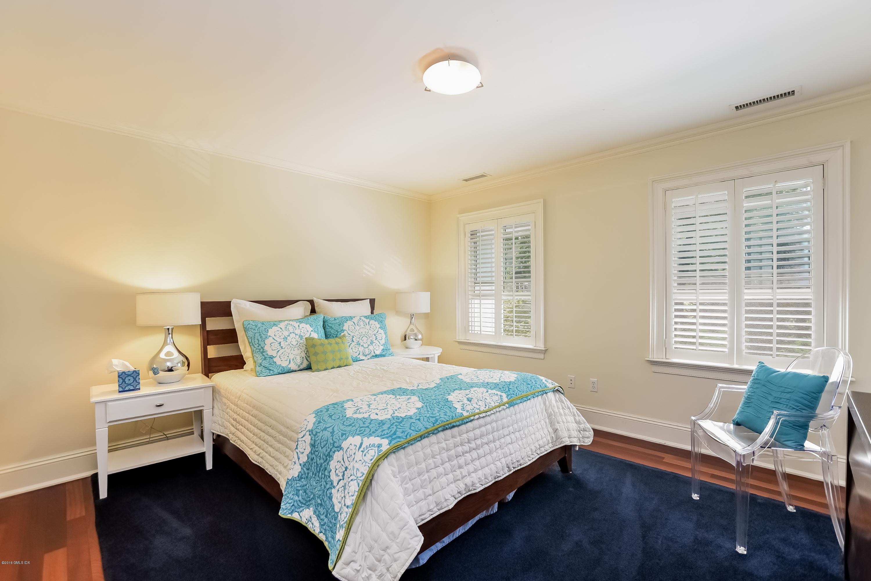 35 Lockwood Road Riverside, CT 06878 - Photo 24 of 39 a bedroom with a bed and windows