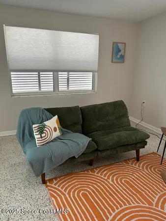 a living room with a couch and a window