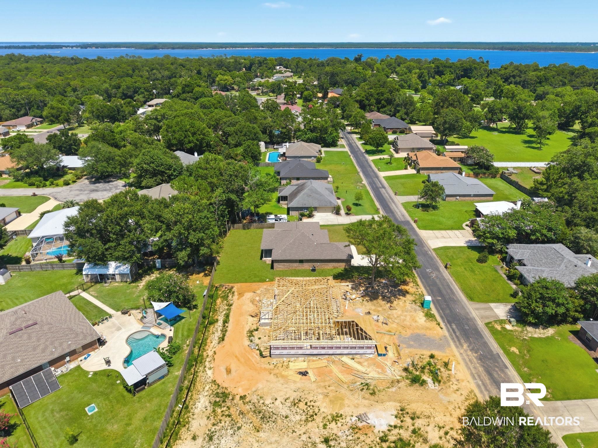 32656 Arbor Ridge Circle Lillian, AL 36549 - Photo 53 of 56 New construction framing on a spacious lot, featuring a concrete slab foundation
