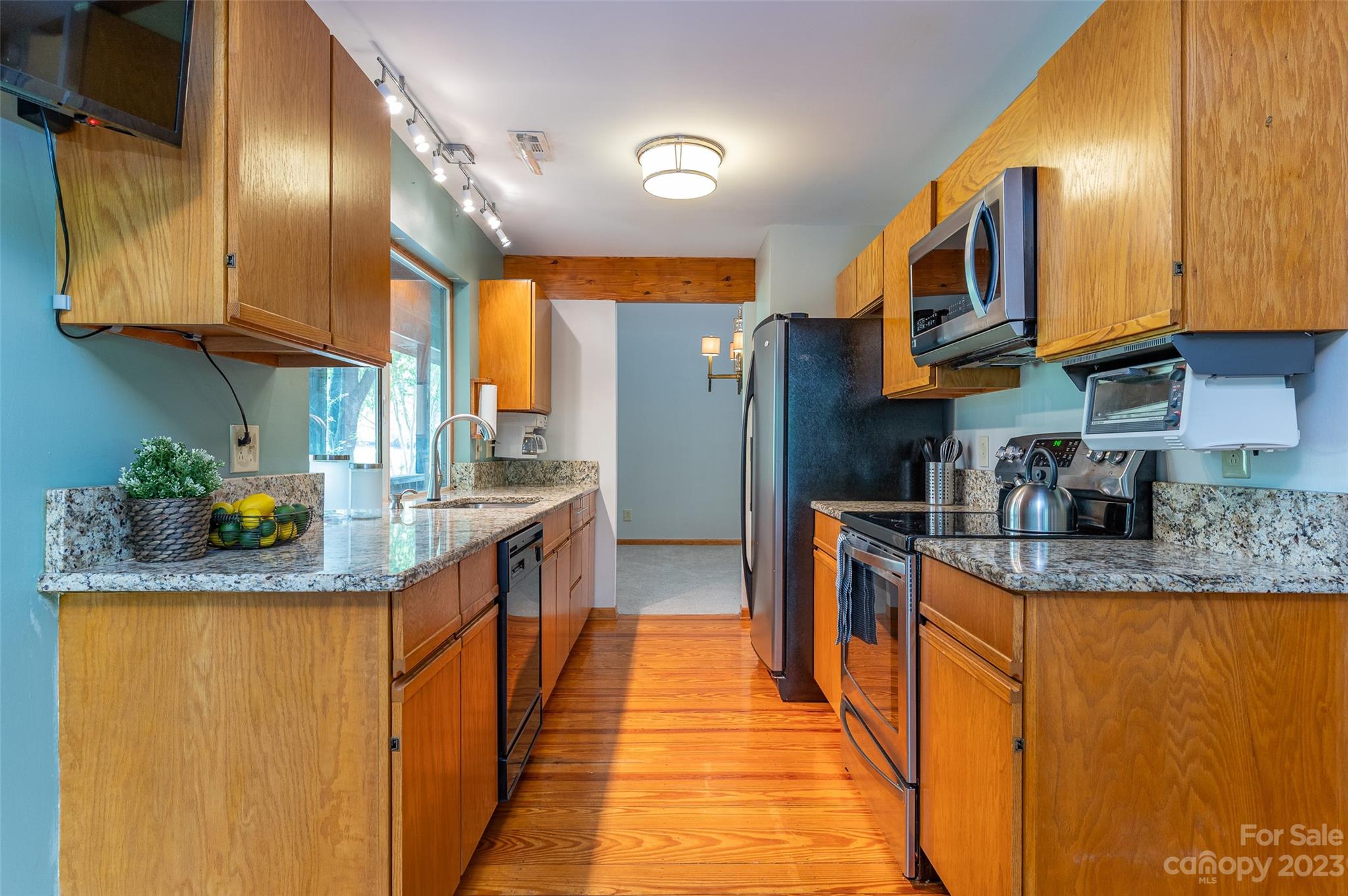 5023 Rounding Run Road Charlotte, NC 28277 - Photo 8 of 38 a kitchen with stainless steel appliances granite countertop a sink a stove and a refrigerator