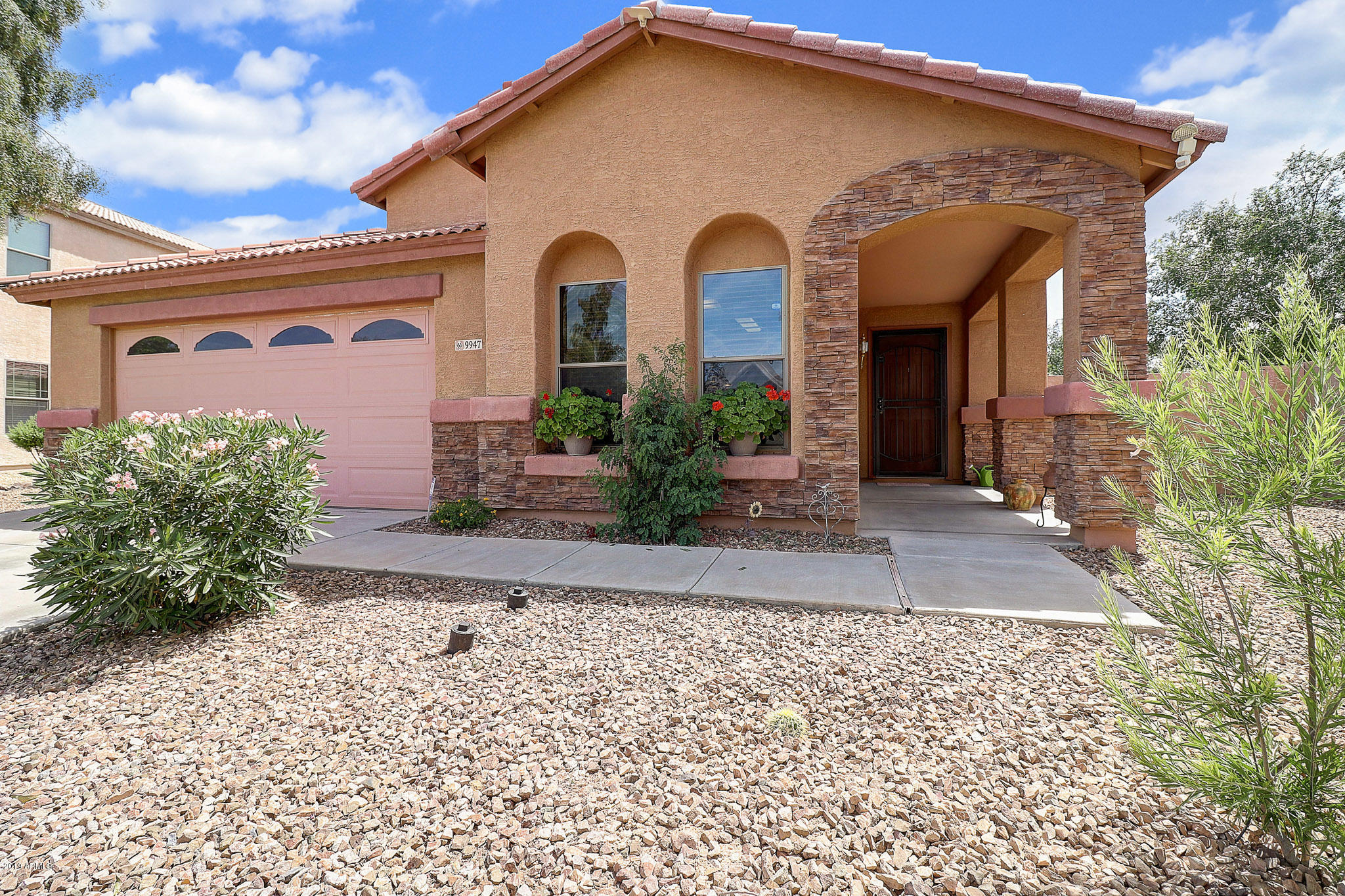 9947 West Riverside Avenue Tolleson, AZ 85353 - Photo 1 of 25 a front view of a house with garden