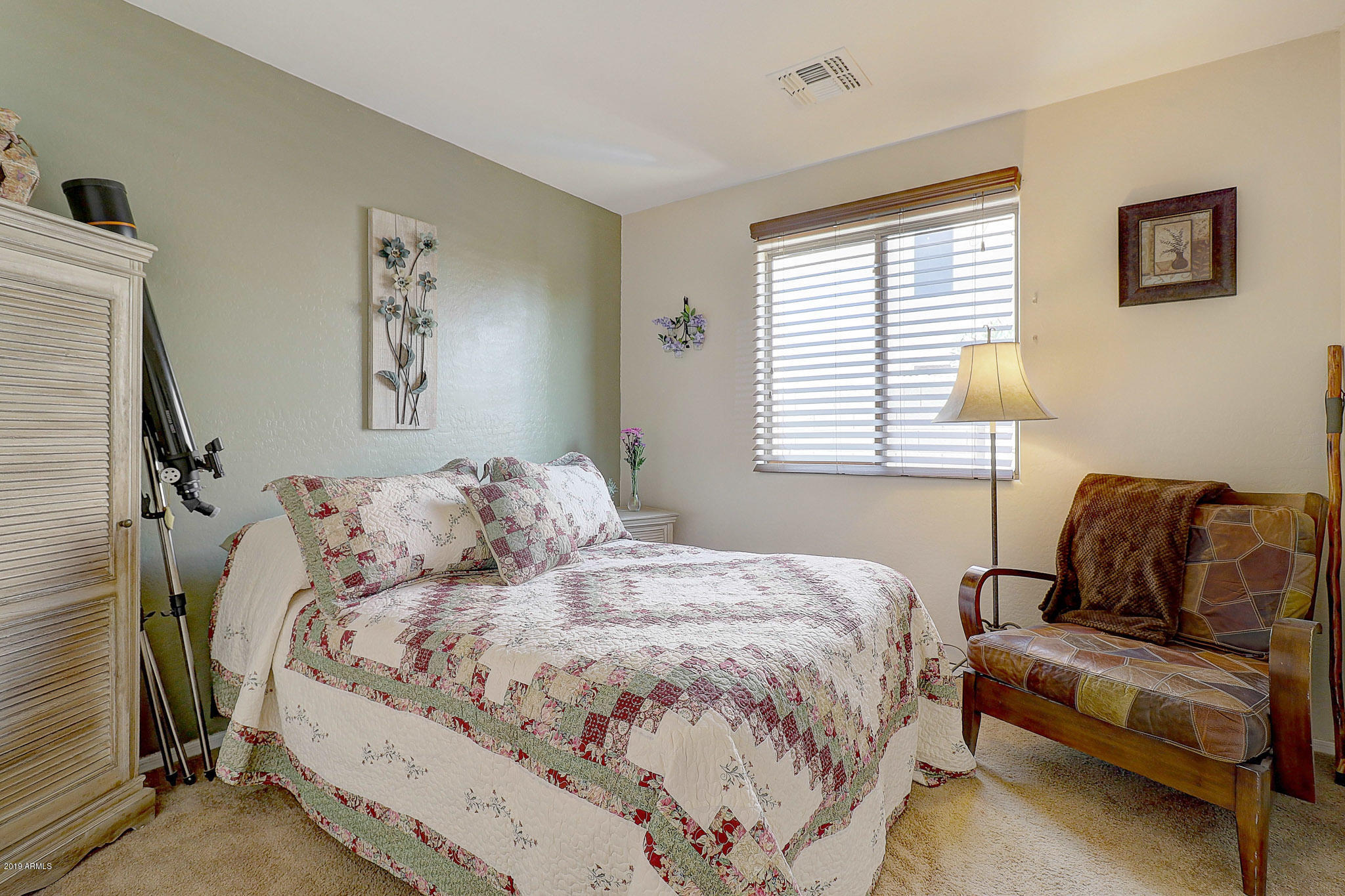 9947 West Riverside Avenue Tolleson, AZ 85353 - Photo 19 of 25 a bedroom with bed and a window