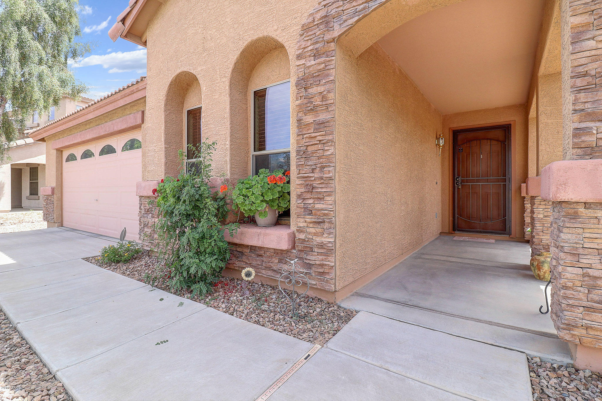 9947 West Riverside Avenue Tolleson, AZ 85353 - Photo 3 of 25 a front view of a house with garden